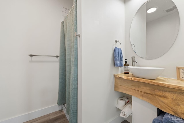 2032 Bay Point Blvd, Milton, FL 32583 - full bathroom featuring vanity, wood finished floors, and curtained shower