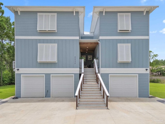 2032 Bay Point Blvd, Milton, FL 32583 - beach home with a garage, driveway, and stairway