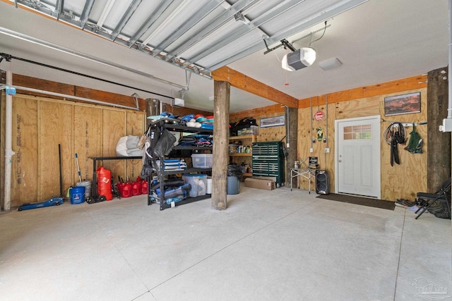 2032 Bay Point Blvd, Milton, FL 32583 - garage featuring a garage door opener and wooden walls