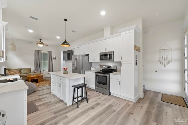2032 Bay Point Blvd, Milton, FL 32583 - kitchen with appliances with stainless steel finishes, light wood-style flooring, white cabinetry, open floor plan, and recessed lighting