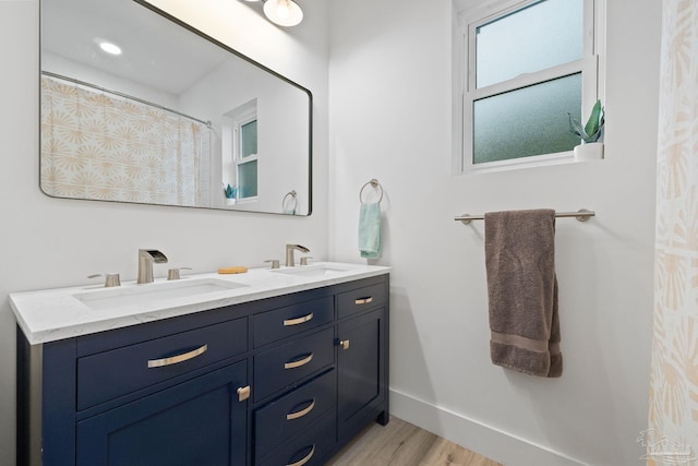 2032 Bay Point Blvd, Milton, FL 32583 - bathroom featuring double vanity and wood finished floors