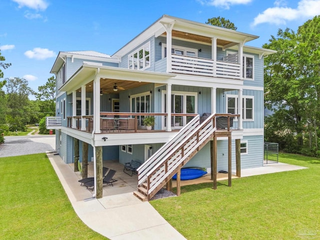 2032 Bay Point Blvd, Milton, FL 32583 - rear view of house featuring a balcony, board and batten siding, ceiling fan, a patio, and a lawn