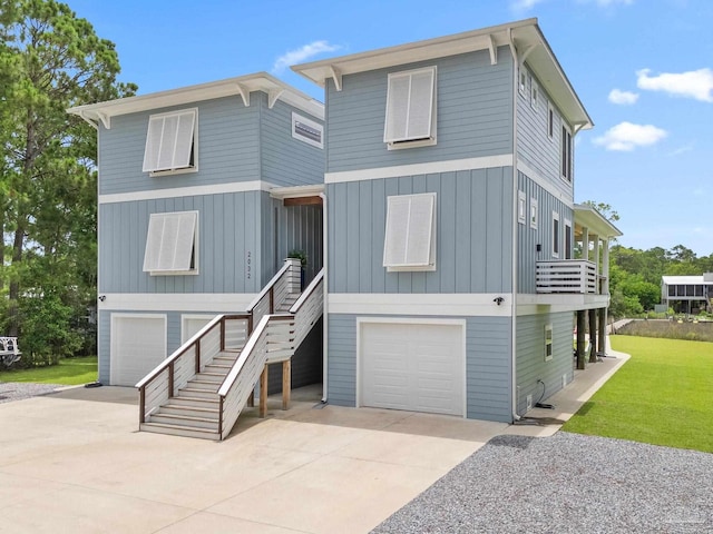 2032 Bay Point Blvd, Milton, FL 32583 - beach home featuring a garage, concrete driveway, board and batten siding, and a front yard