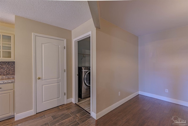 interior space featuring a textured ceiling and dark hardwood / wood-style floors