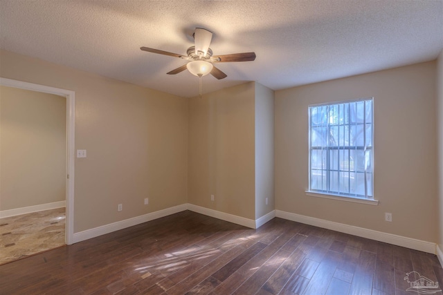 unfurnished room with ceiling fan, dark wood-type flooring, and a textured ceiling