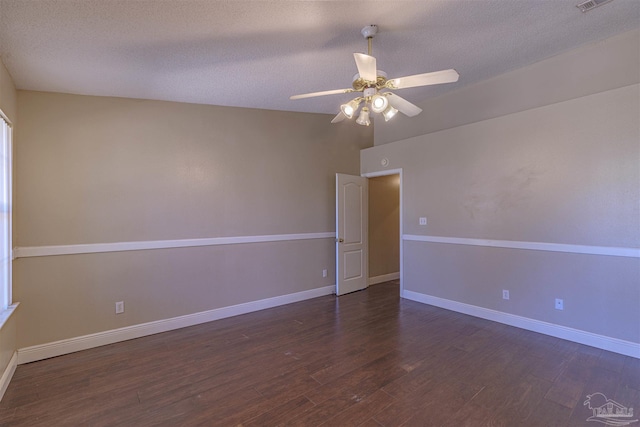 unfurnished room featuring ceiling fan, dark hardwood / wood-style floors, and a textured ceiling