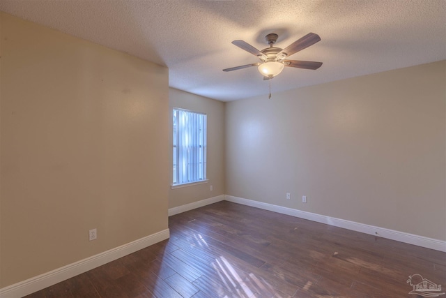 spare room featuring a textured ceiling, ceiling fan, and dark wood-type flooring