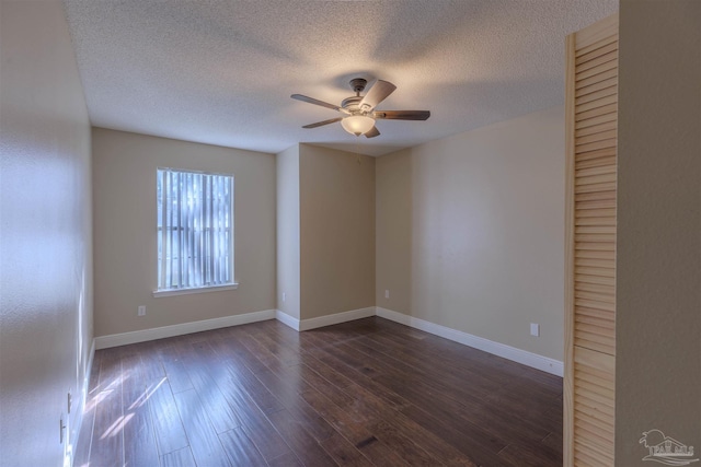 empty room featuring a textured ceiling, ceiling fan, and dark wood-type flooring