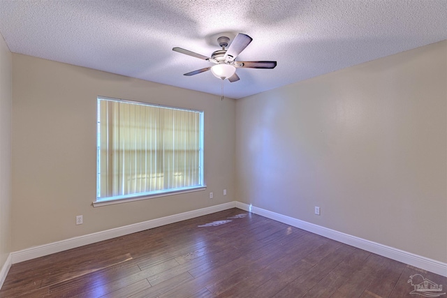 unfurnished room with a textured ceiling, ceiling fan, and dark wood-type flooring