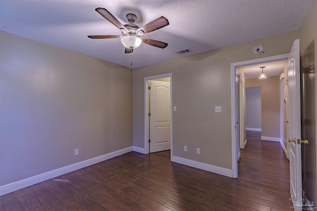 unfurnished bedroom with ceiling fan, dark wood-type flooring, and a textured ceiling