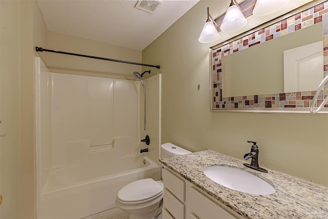 full bathroom with vanity, a textured ceiling, toilet, and shower / washtub combination