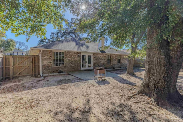 rear view of house featuring french doors and a patio area