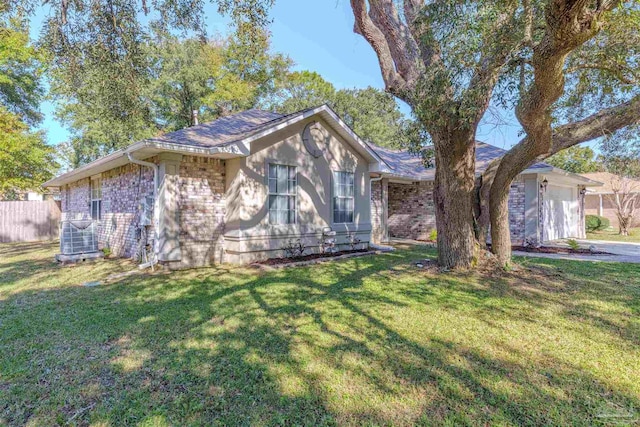 ranch-style home with central air condition unit, a front lawn, and a garage