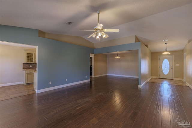 interior space with ceiling fan, hardwood / wood-style floors, and lofted ceiling