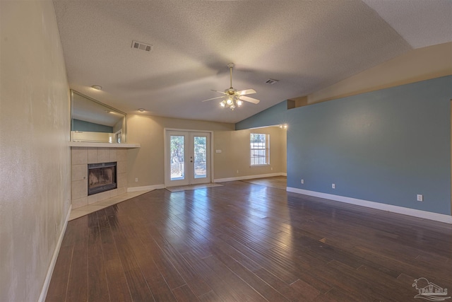 unfurnished living room with ceiling fan, wood-type flooring, french doors, and vaulted ceiling