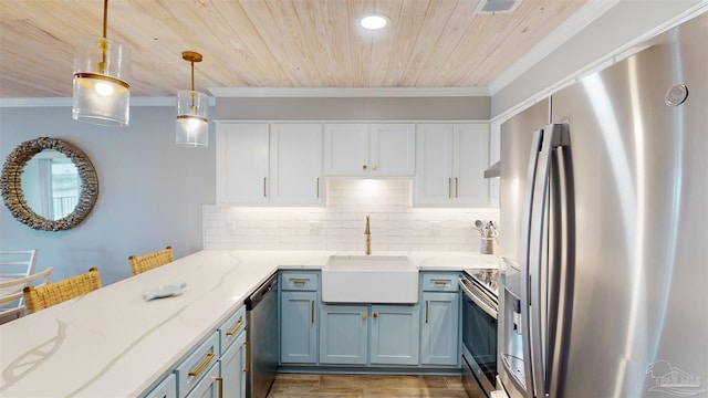 kitchen featuring light wood-type flooring, sink, decorative light fixtures, appliances with stainless steel finishes, and light stone countertops