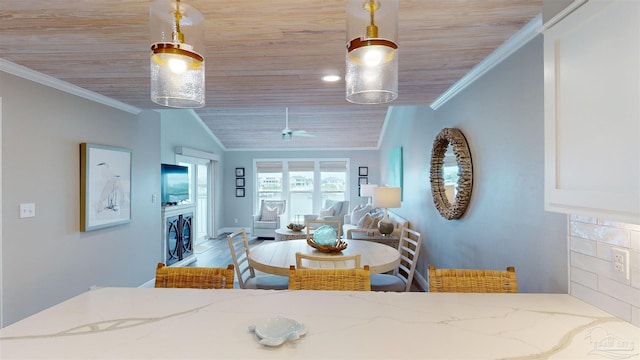 dining space featuring wood ceiling, ornamental molding, and ceiling fan