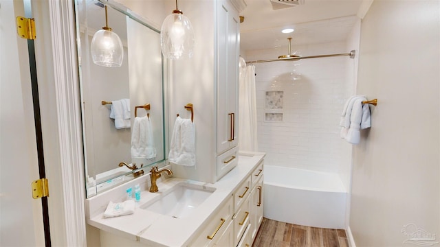 bathroom featuring shower / tub combo with curtain, vanity, and hardwood / wood-style floors