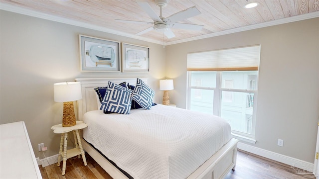 bedroom with light wood-type flooring, wood ceiling, ornamental molding, and ceiling fan