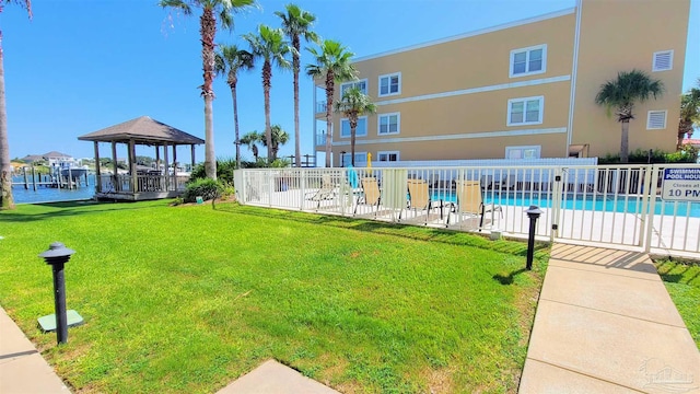 exterior space featuring a lawn, a gazebo, and a swimming pool