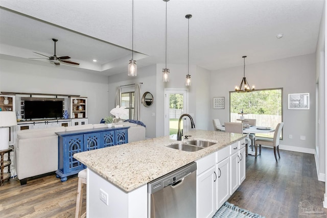 kitchen featuring white cabinets, a kitchen island with sink, a sink, and dishwasher