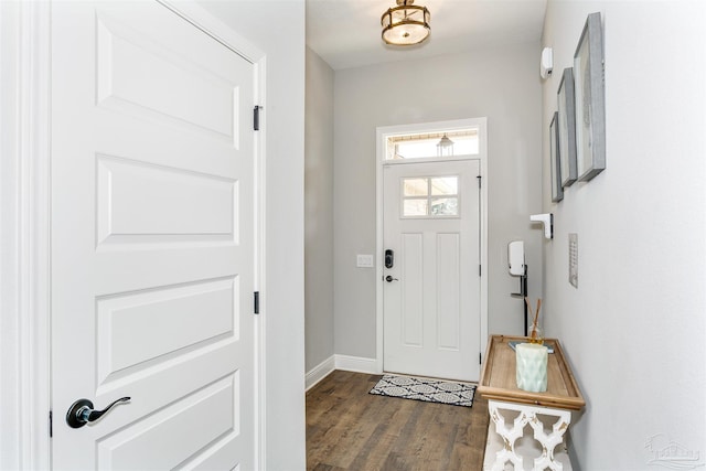 foyer entrance featuring dark wood-style floors and baseboards