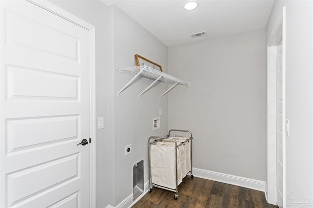 clothes washing area featuring dark wood-style floors, washer hookup, visible vents, laundry area, and baseboards