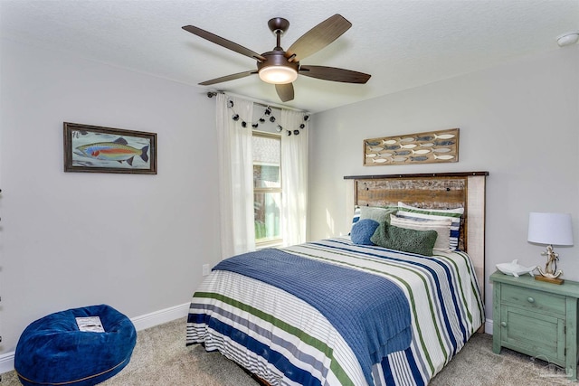 bedroom featuring carpet, baseboards, ceiling fan, and a textured ceiling