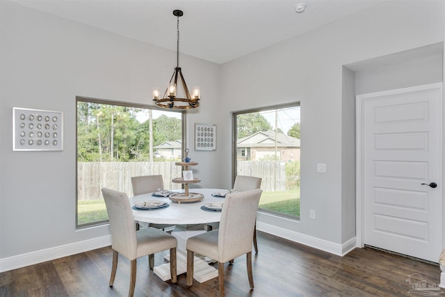 dining space featuring a notable chandelier, baseboards, and dark wood-type flooring