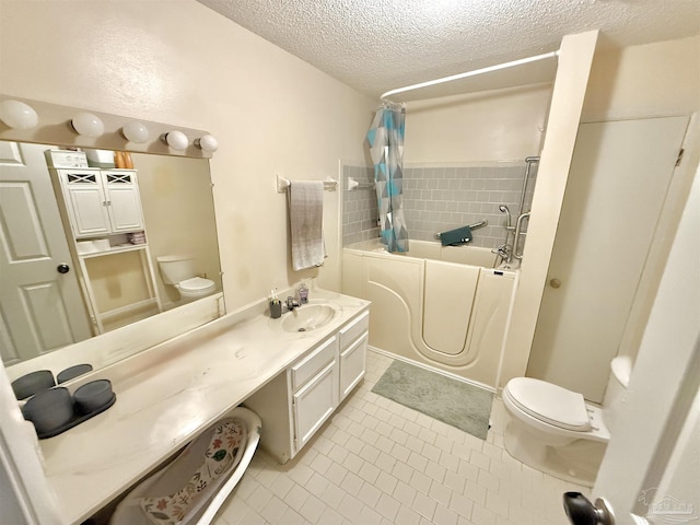 bathroom featuring tile patterned flooring, a textured ceiling, vanity, and toilet