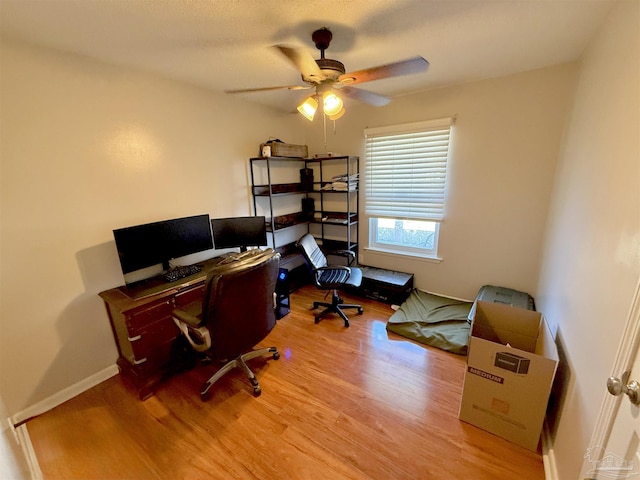 home office featuring hardwood / wood-style flooring and ceiling fan