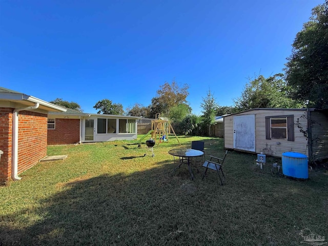 view of yard with a playground and a storage shed