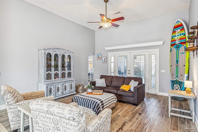 living room featuring ceiling fan and french doors