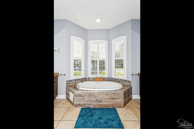 bathroom with tile patterned flooring and a relaxing tiled tub