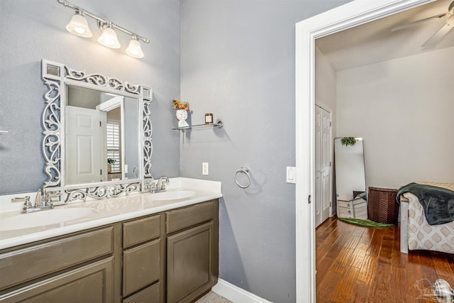 bathroom featuring ceiling fan, hardwood / wood-style floors, and vanity