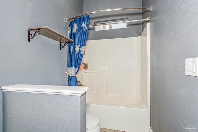 bathroom with tile patterned floors, shower / bathtub combination with curtain, and toilet