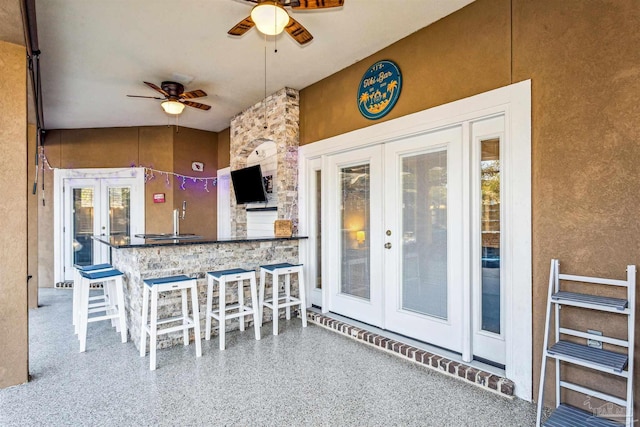 view of patio / terrace with ceiling fan and a wet bar