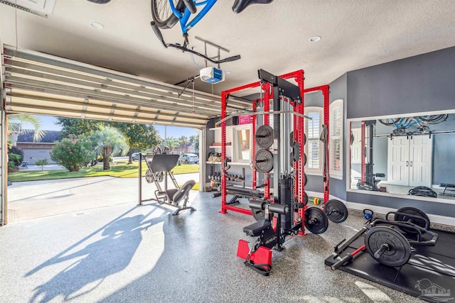 exercise room with plenty of natural light and a textured ceiling