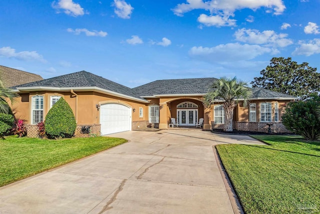 ranch-style home featuring french doors, a garage, and a front lawn