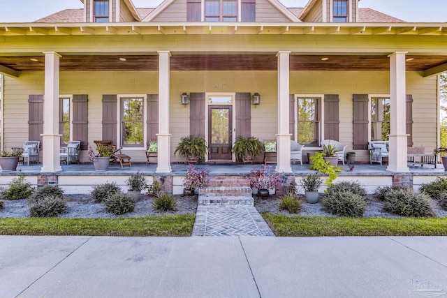 view of exterior entry featuring a porch