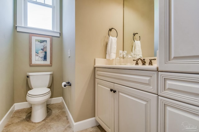 bathroom featuring tile patterned flooring, vanity, and toilet