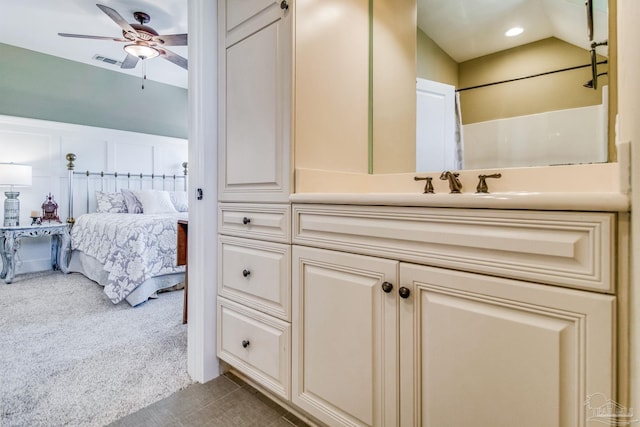 bathroom featuring ceiling fan, lofted ceiling, and vanity