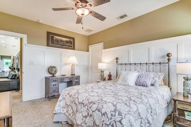 bedroom featuring light colored carpet and ceiling fan