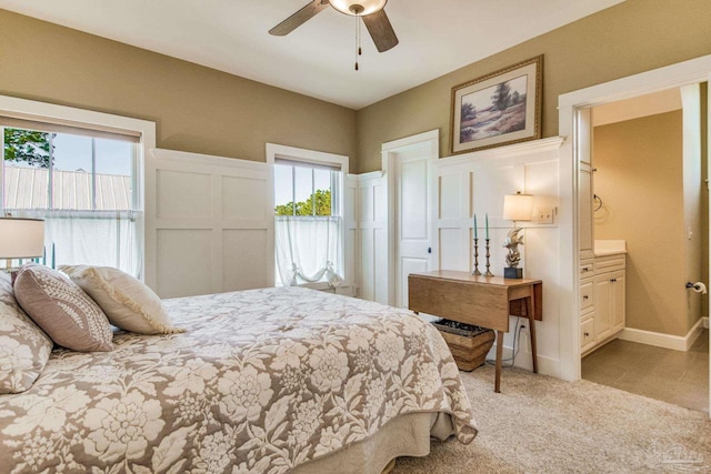 carpeted bedroom featuring multiple windows and ceiling fan