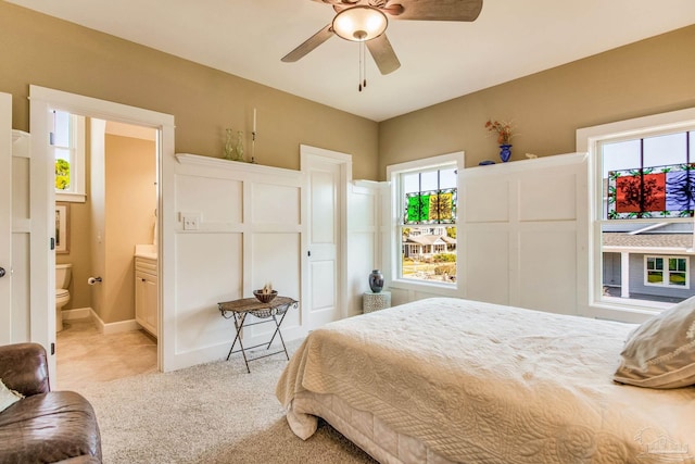 carpeted bedroom featuring ceiling fan and connected bathroom