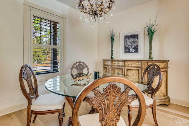 dining room featuring light hardwood / wood-style flooring and a notable chandelier