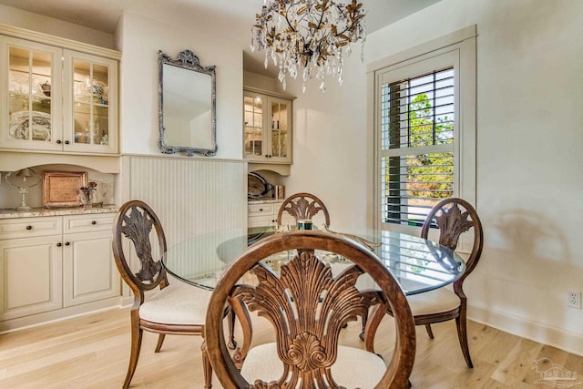 dining room featuring a notable chandelier and light wood-type flooring