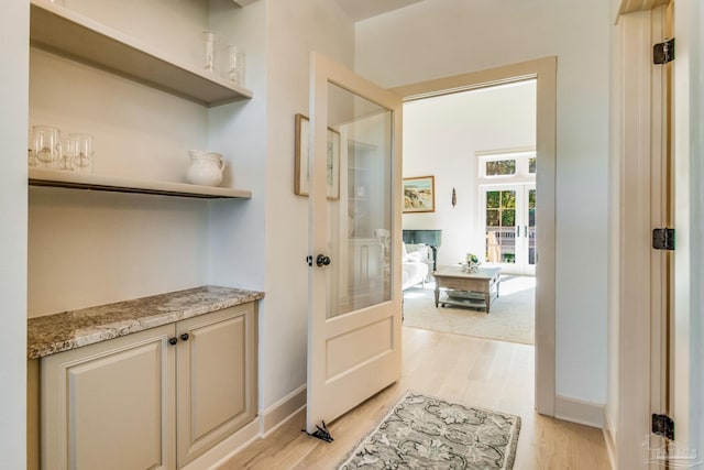 hall featuring french doors and light wood-type flooring