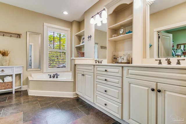 bathroom with a tub and vanity