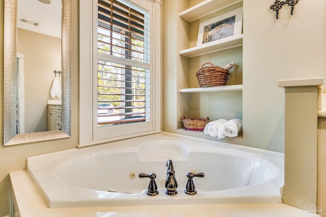 bathroom with vanity and a tub to relax in